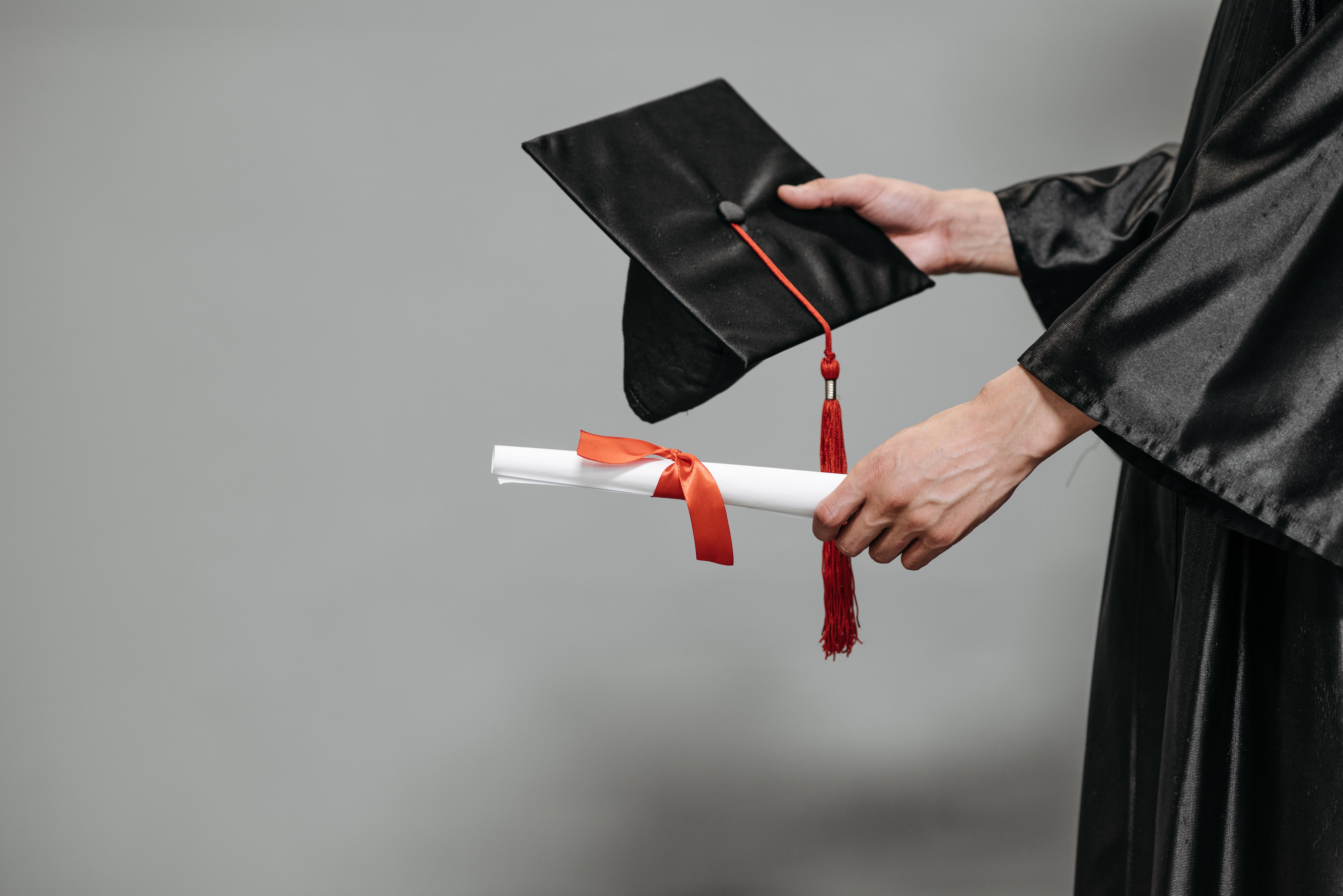 Graduate holding a cap and diploma